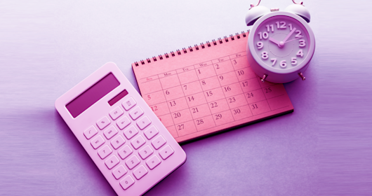 calculator, clock and calendar on desk